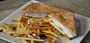 A turkey sandwich accompanied by a side of french fries sits on a table at The People's Kitchen, ready to be eaten on Sunday, March 1, 2015. The People's Kitchen is a recently-opened breakfast and brunch restaurant which the owner, Billy Gruenewald, describes as "hipster-traditional." (Jackie Peterson/B&W photo)