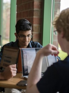 Deep Sheth, '18, and his partners get to work on their program at the rVibe & Coding the Future Hackathon in Sayre Park Lodge on Saturday, April 25, 2015. The event, co-hosted by rVibe, a local startup, and the Code for the Future House, offered prizes including internship interviews, tablets, and hard drives. (Chris Barry/B&W Photo)