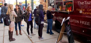 Students wait in line to order lunch at The Taza Truck on Thursday, Oct. 30, 2015. The Taza Truck is one of the many vendors at the Farmer's Market. Thursday was the last day of the Farmer's Market until the spring.