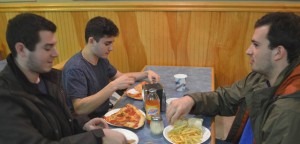 Zach Davis, ’18, Ethan Schneider, ’18, and Derek Freyberg ’17 eat dinner at Campus Pizza on Tuesday, Feb. 16, 2016 during Colleges Against Cancer Restaurants Week. A portion of the proceeds help support Lehigh's Relay for Life fund. (Alexis McGowan/B&W Staff)