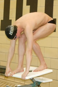 Jacob Moyar, a junior on the men's swimming and diving team, stands on the blocks getting ready to dive into the pool to start off practice on Friday, Feb. 26, 2016 in Taylor Gym. Moyar recently placed fourth in the 200 butterfly in the Patriot League Championships on Feb. 20, 2016. (Gracie Chavers/B&W Staff)