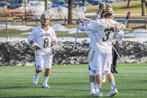 Freshman attackman/midfielder Mickey Fitzpatrick is embraced by a fellow teammate during the men's lacrosse home game on Sunday, Feb. 6, 2016. Lehigh won against NJIT by 17 points. (Hallie Fuchs/B&W Staff)