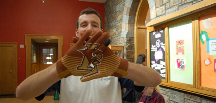 Mark Schatzman, '17, shows off the spirit gloves the class officers sold last November to promote Lehigh-Lafayette spirit week on Monday, Nov. 14, 2016. Last semester the Lehigh Fund discontinued the class officers program, which aimed to solicit donations from Lehigh students. (Kate Morrell/B&W Staff)
